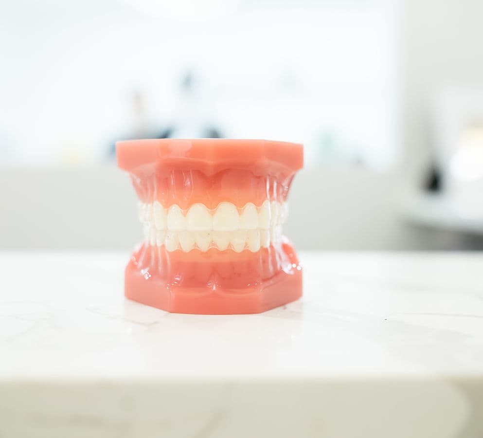A technician finishing a denture in the Dream Smile Dental laboratory