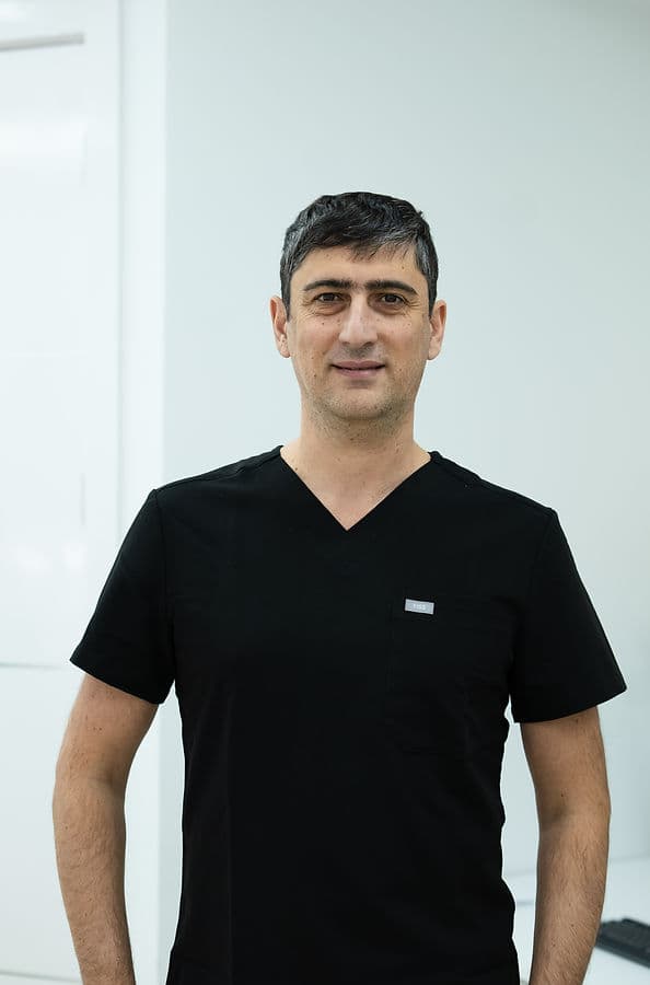 Slava, master dental technician, in black scrubs at Dream Smile Dental